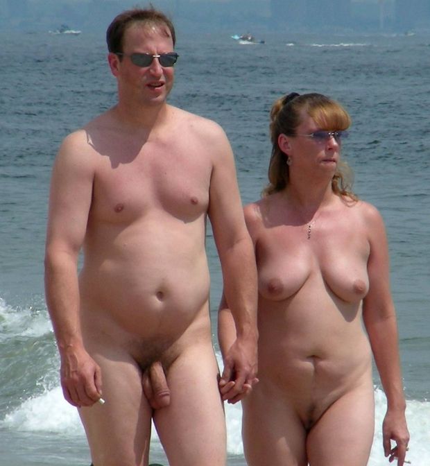 naked man and wife walking at beach