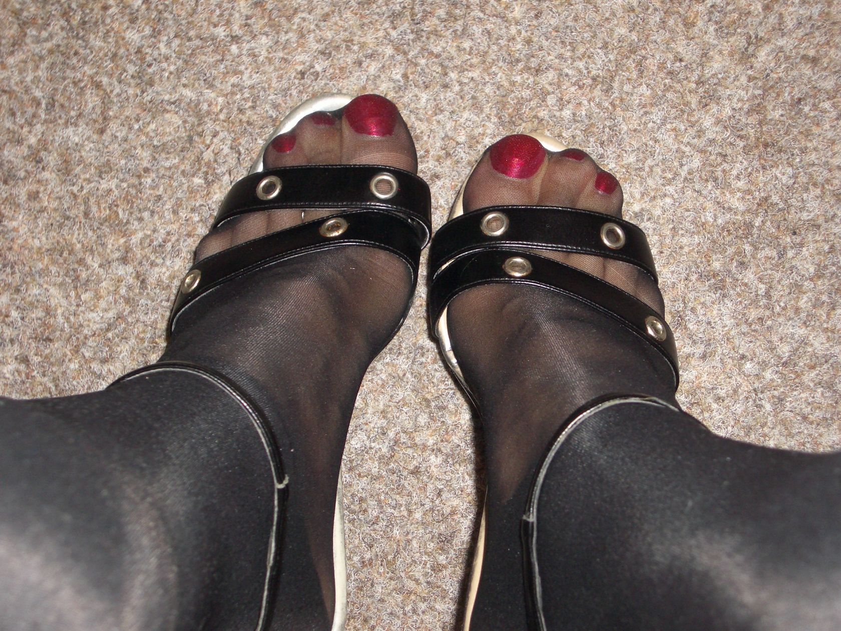 red toenails in black nylon and heels