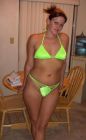 Sexy amateur woman in neon green string bikini at home