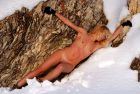 blond-laying-on-a-rock-in-the-snow-tits-and-pussy-exposed-1608